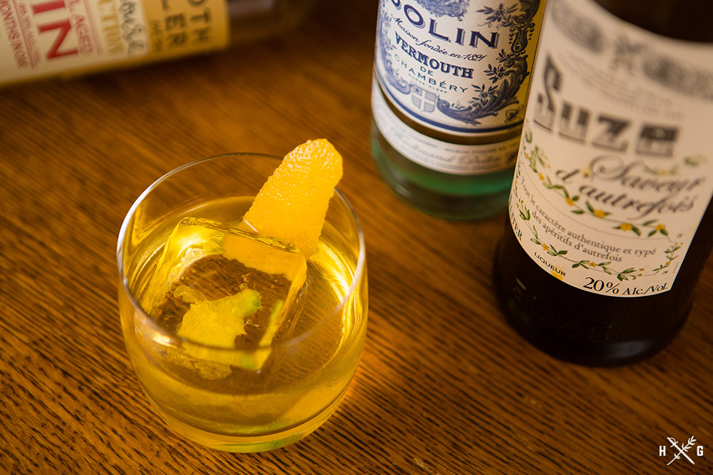 white negroni with flower encased in ice cube