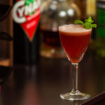 Blushing Monk cocktail garnished with mint sprig