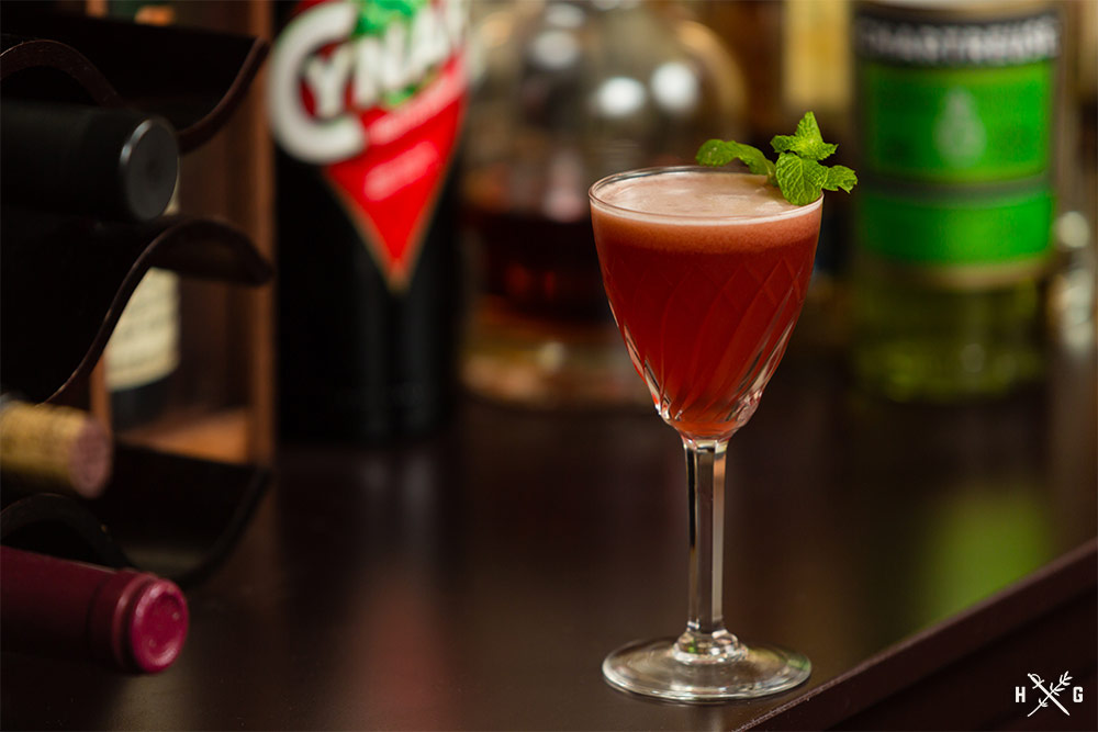 Blushing Monk cocktail garnished with mint sprig